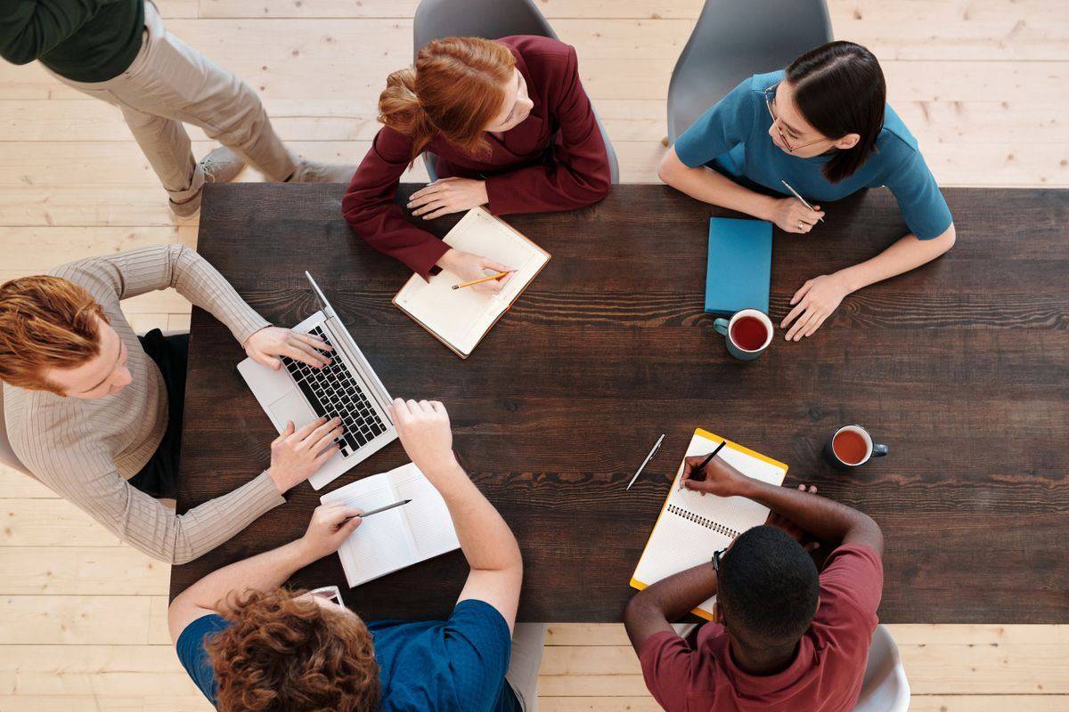 Colleagues collaborating around a wooden table